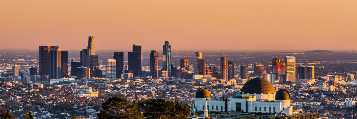 Los Angeles skyscrapers and Griffith Observatory at sunset by photoquest7 from Getty Images Pro